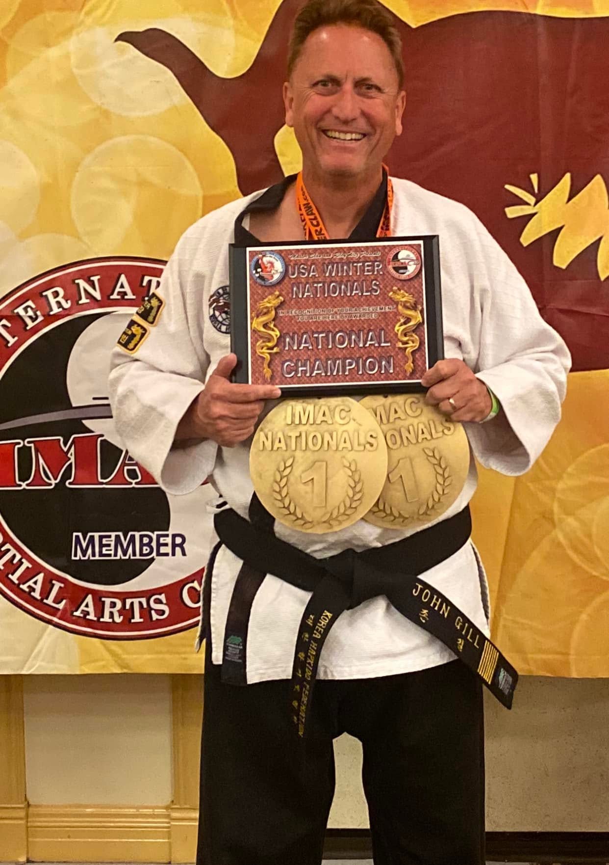 Grandmaster John Gill with his USA Winter Nationals National Champion plaque and two gold medals